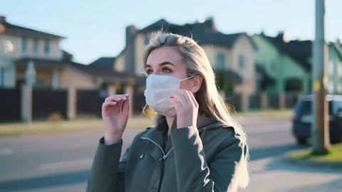 Pretty girl taking off mask outdoor Stock Footage