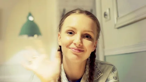 Pretty girl talking to camera in the cafe and answers her cellphone Stock Footage 66514345