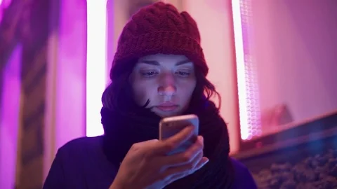 Pretty girl texting using app on smart phone at night in city. Stock Footage 83072378