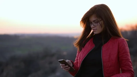 Pretty girl using app on mobile phone. Stock Footage 89876307