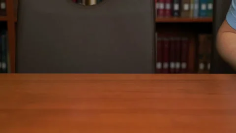 Pretty girl using computer tablet in the library or in the office. Stock Footage 97147274