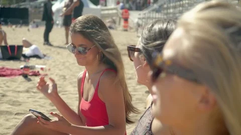 Pretty girl using her smartphone at the beach Stock Footage 78366628