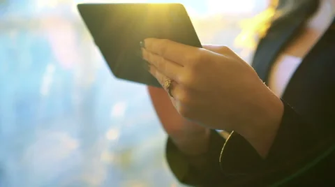Pretty girl using tablet against the background of a window, zoom Stock-Footage 60080410