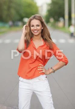 Pretty girl walking outdoors Stock Photos