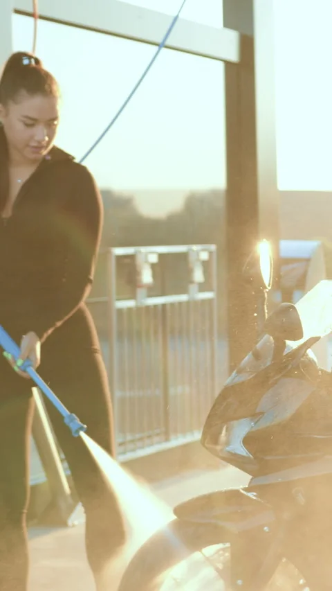 Pretty in good mood stylish 25-aged female motorcyclist with high ponytail in tr Stock Footage 331079593