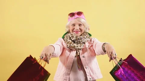Pretty granny has bought presents, clothes for her granddaughters and grandsons. Stock Footage 117901854