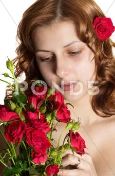 Pretty green-eyed girl with a bouquet of red roses Stock Photos
