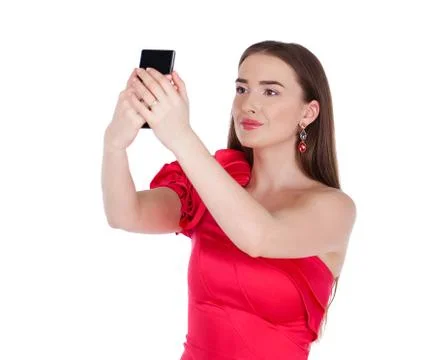 Pretty happy brunette woman making selfie on smartphone, isolated on whiteM Stock Photos