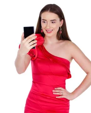 Pretty happy brunette woman making selfie on smartphone, isolated on whiteM Stock Photos