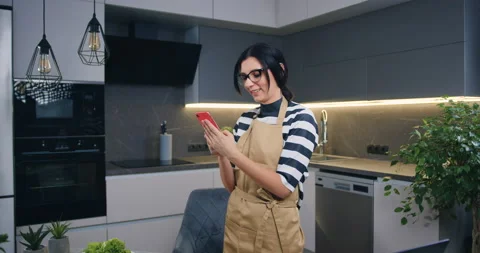 Pretty happy joyful dark-haired woman in glasses standing in the middle of Stock Footage 148866324