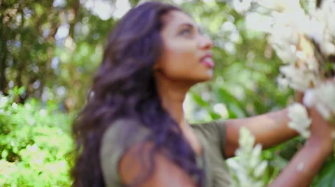 Pretty Indian Asian female in the park s... | Stock Video | Pond5