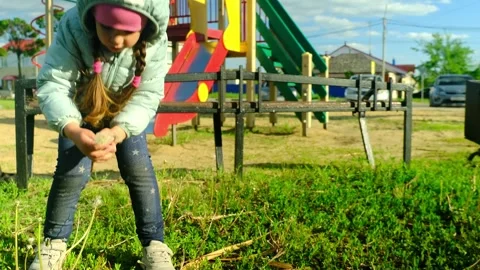 Pretty kid playing and smiling outside in a park. Happy little girl playing outs Stock Footage 277502777