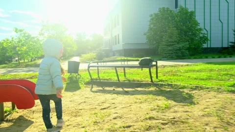Pretty kid playing and smiling outside in a park. Happy little girl playing outs Stock Footage 277503122