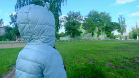 Pretty kid playing and smiling outside in a park. Happy little girl playing outs Stock Footage 277624654