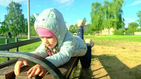 Pretty kid playing and smiling outside in a park. Happy little girl playing outs Stock Footage 278054054