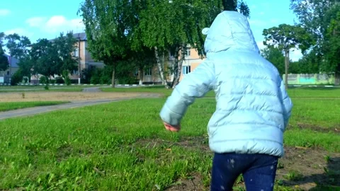 Pretty kid playing and smiling outside in a park. Happy little girl playing outs Stock Footage 278224879
