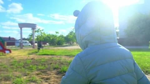 Pretty kid playing and smiling outside in a park. Happy little girl playing outs Stock Footage 278224907