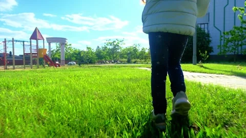 Pretty kid playing and smiling outside in a park. Happy little girl playing outs Stock Footage 278345213
