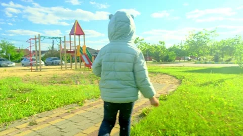 Pretty kid playing and smiling outside in a park. Happy little girl playing outs Stock Footage 278345246