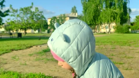 Pretty kid playing and smiling outside in a park. Happy little girl playing outs Stock-Footage 278739231
