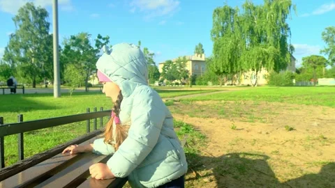 Pretty kid playing and smiling outside in a park. Happy little girl playing outs Stock Footage 279073674
