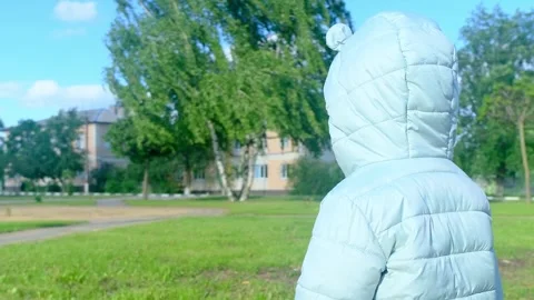 Pretty kid playing and smiling outside in a park. Happy little girl playing outs Stock Footage 279655609