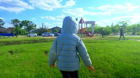 Pretty kid playing and smiling outside in a park. Happy little girl playing outs Stock Footage 280209710