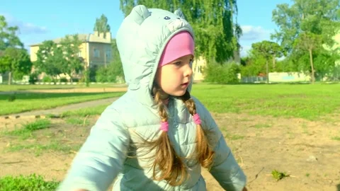 Pretty kid playing and smiling outside in a park. Happy little girl playing outs Stock Footage 280209740