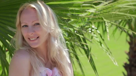 Pretty lady and palm tree. Stock Footage 49444480