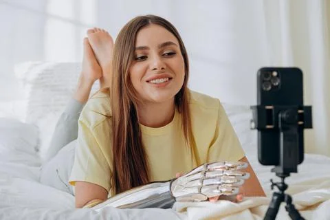 Pretty lady with bionic arm shoots new video with phone Stock Photos