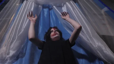 Pretty lady dances trying to break free from plastic capsule Stock Footage 115255372