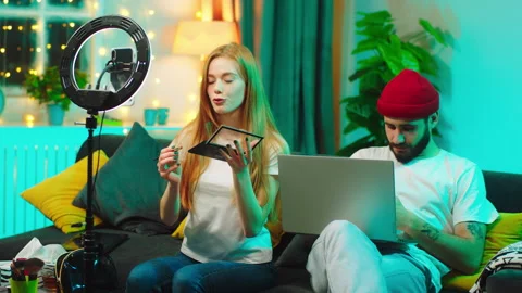 Pretty lady make a live stream for her social media account to showing how to do Stock Footage 146466504