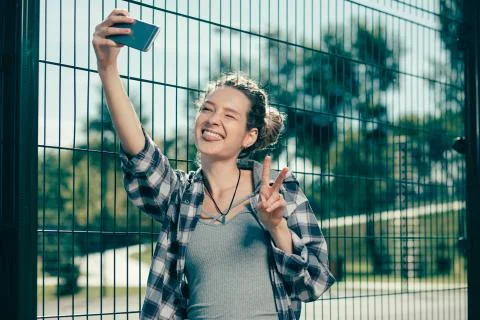 Pretty lady making silly faces while taking selfies Stock Photos