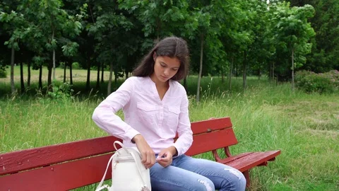 Pretty lady opens white bag and makes notes in blue notebook Video stock 115397904