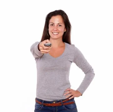 Pretty lady pointing remote control while standing Stock Photos