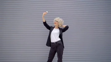 Pretty lady with red lipstick does selfie on her fashionable smartphone Stock-Footage 85994474