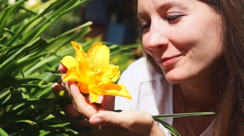 Pretty lady smells flower Stock Footage 53274535