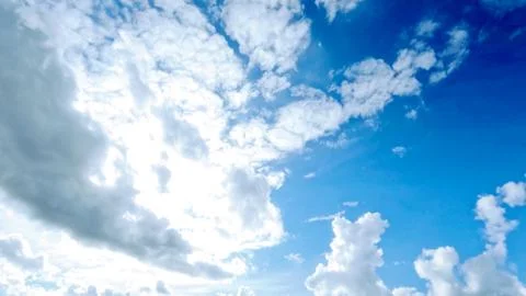 Pretty large clouds in the blue sky background - photo of nature Stock Photos