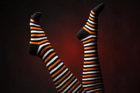 Pretty legs in  a long multi-colored socks Stock Photos