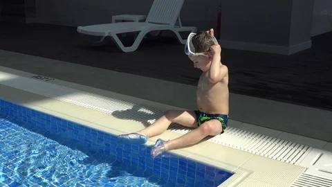 Pretty little boy is playing in the pool Stock Footage 82410659