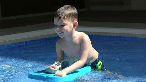 Pretty little boy  in the pool Stock Footage 80570350