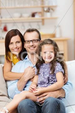 Pretty little girl with her proud parents Stock Photos