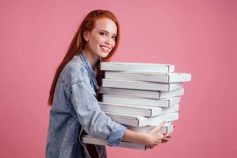 Pretty long ginger red-haired woman holding a lot of boxes with fast food snack Photos