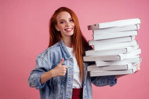 Pretty long ginger red-haired woman holding a lot of boxes with fast food snack Stock Photos