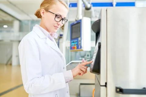 Pretty Machine Operator Adjusting Equipment Stock Photos