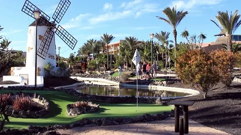 Pretty mini-golf course with pool and windmill Stock Footage 84756747