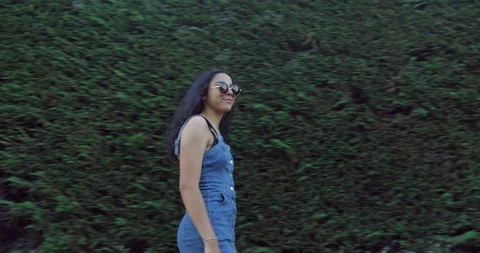 A Pretty Mix Race Young Student Girl Exploring The British Streets On Sunny day. Stock Footage 94530884