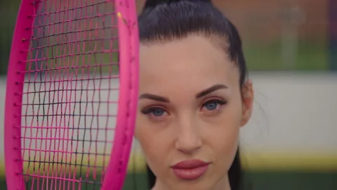 Pretty model with beautiful big bright blue eyes holding racket. Stock Footage 164838064