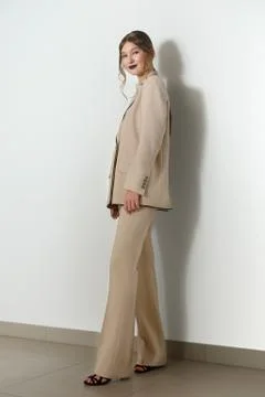 Pretty model in beige jacket and trousers suite, attractive make up posing ne Stock-Fotos