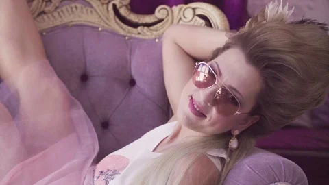 Pretty model in peignoir posing against white wall Stock Footage 88639314